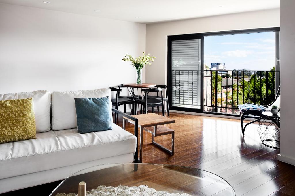 a living room with a couch and a table at Veriu Randwick in Sydney