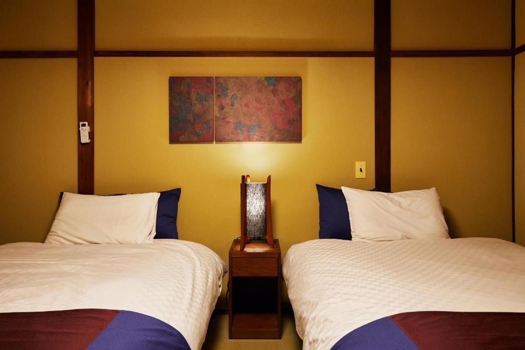 Postel nebo postele na pokoji v ubytování Kyomachiya Hotel Mifuku
