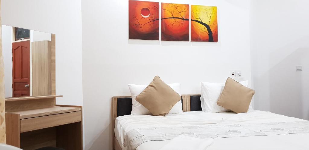 Postel nebo postele na pokoji v ubytování Arora Inn