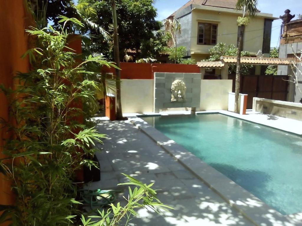 a swimming pool in the backyard of a house at Merpati - Studios in Sanur