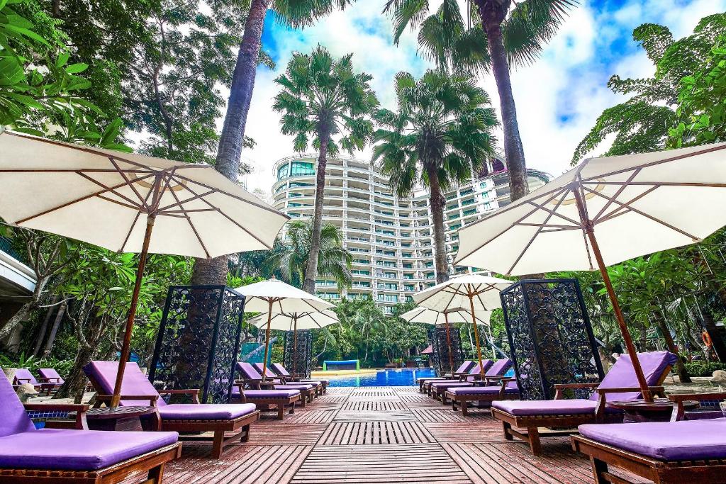a row of chairs and umbrellas at a resort at Ocean Sonic Resort Sanya in Sanya