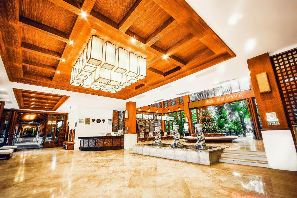 a large room with wooden ceilings and a lobby at Ocean Sonic Resort Sanya in Sanya