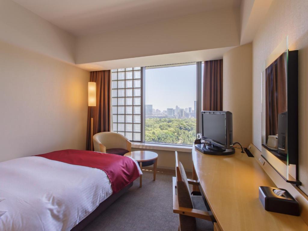 a hotel room with a bed and a large window at Hotel Grand Arc Hanzomon in Tokyo