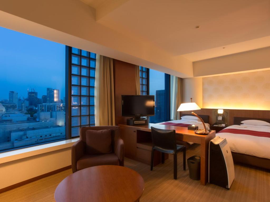 a hotel room with a bed and a large window at Hotel Grand Arc Hanzomon in Tokyo