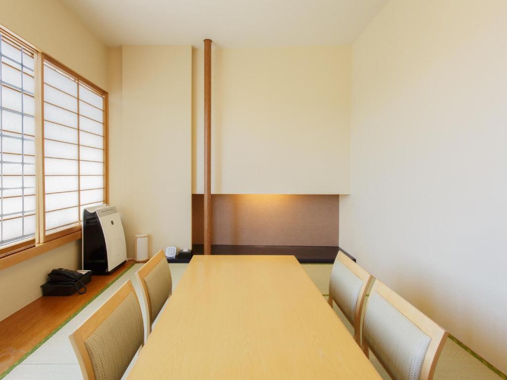a conference room with a wooden table and chairs at Hotel Grand Arc Hanzomon in Tokyo