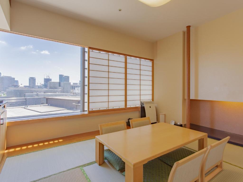 a dining room with a table and a large window at Hotel Grand Arc Hanzomon in Tokyo