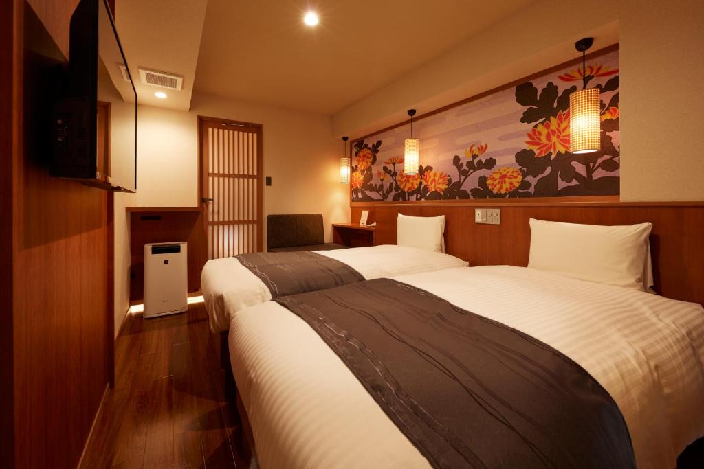 Postel nebo postele na pokoji v ubytování Sakura Sky Hotel