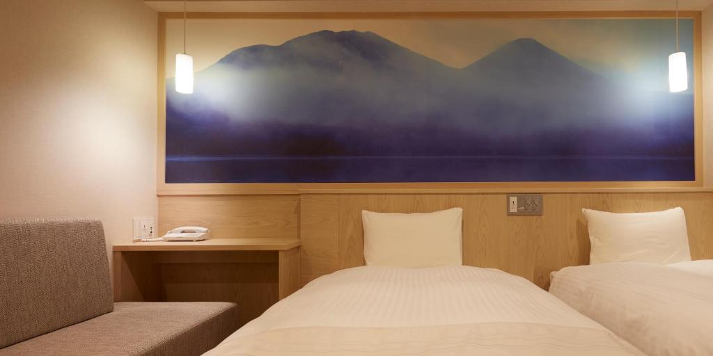 Postel nebo postele na pokoji v ubytování Sakura Sky Hotel