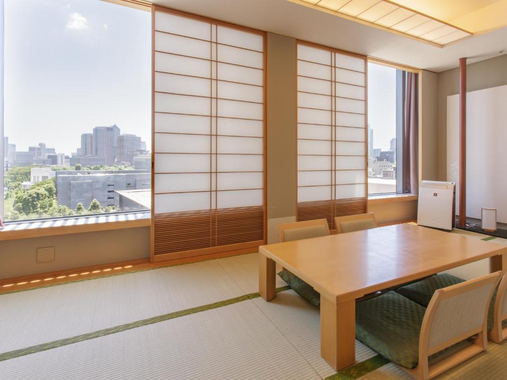 a dining room with a table and a large window at Hotel Grand Arc Hanzomon in Tokyo