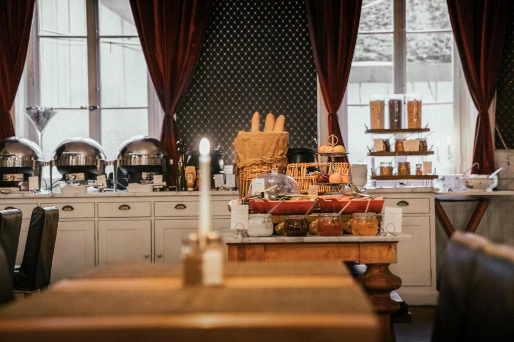 a table in a kitchen with a candle on it at Langley Hotel Gustavia in Chamonix
