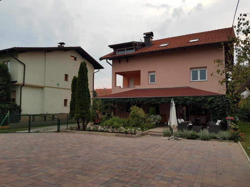 a large house with a patio and an umbrella at A&T Apartment in Zaprešić