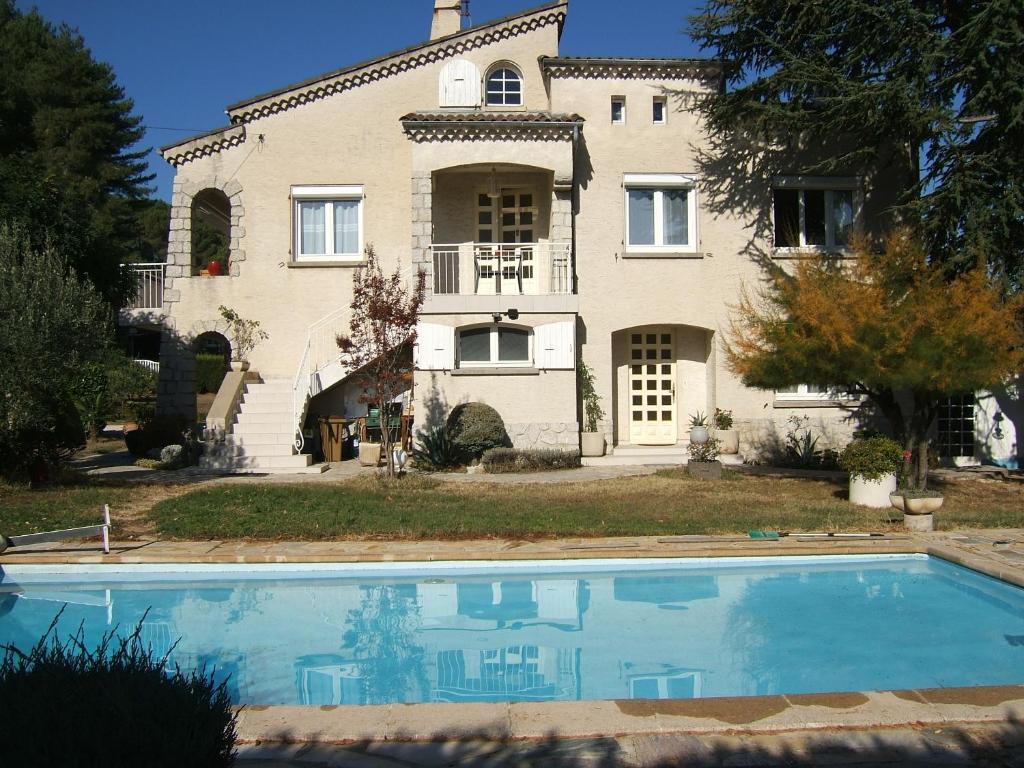 a house with a swimming pool in front of it at Domaine de Lazuel in Aubenas