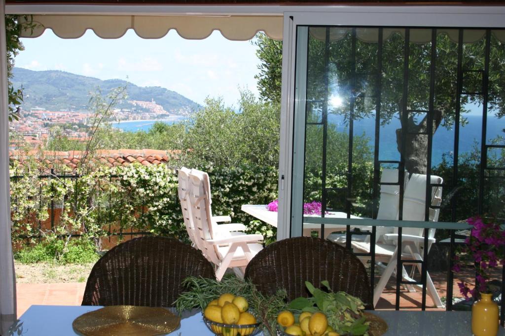a table and chairs on a patio with a view at Villa Panorama in Diano Marina
