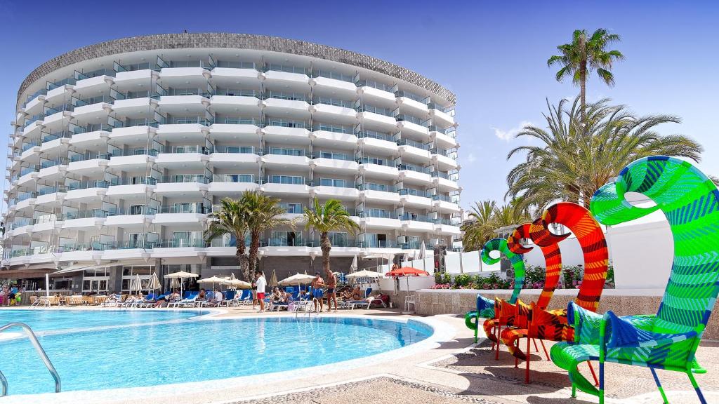 un complejo con piscina y un gran edificio en Bull Escorial & SPA, en Playa del Inglés