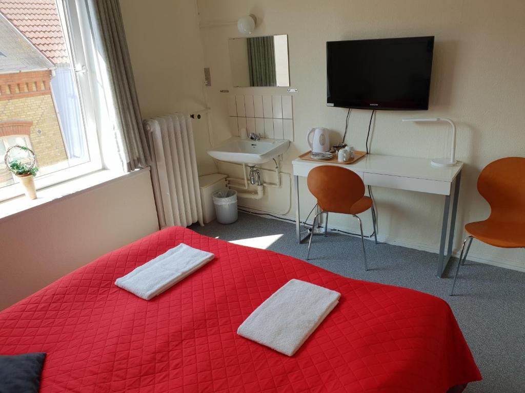 Postel nebo postele na pokoji v ubytování Hotel Aabenraa
