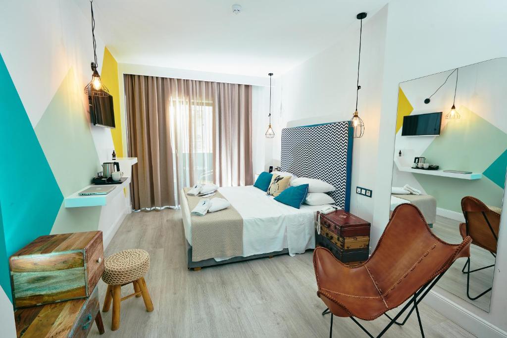Postel nebo postele na pokoji v ubytování Blue Bottle Boutique Hotel