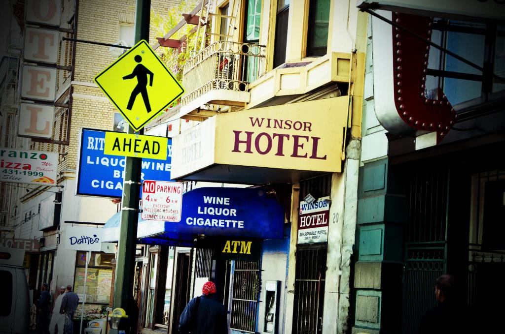 a street with signs on the side of a building at Winsor Hotel in San Francisco