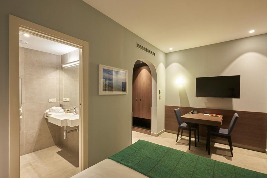 TV a/nebo společenská místnost v ubytování M Suite Hotel