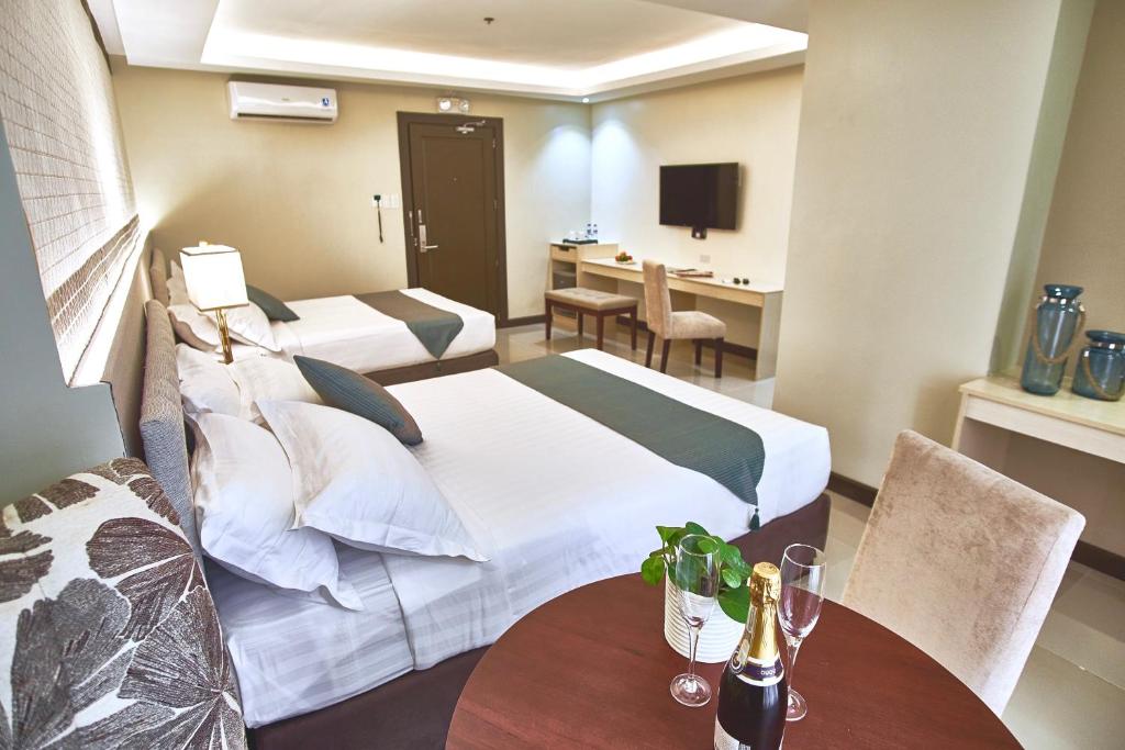 Postel nebo postele na pokoji v ubytování J7 Hotel