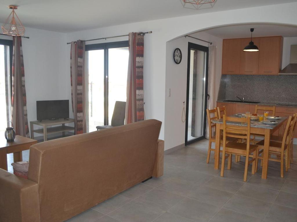a kitchen and dining room with a table and chairs at Le Domaine De Marie in Palasca