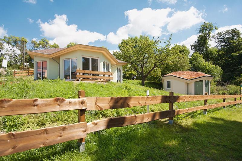 una valla de madera frente a una casa en Ferienhäuser am Hainich en Hörselberg-Hainich