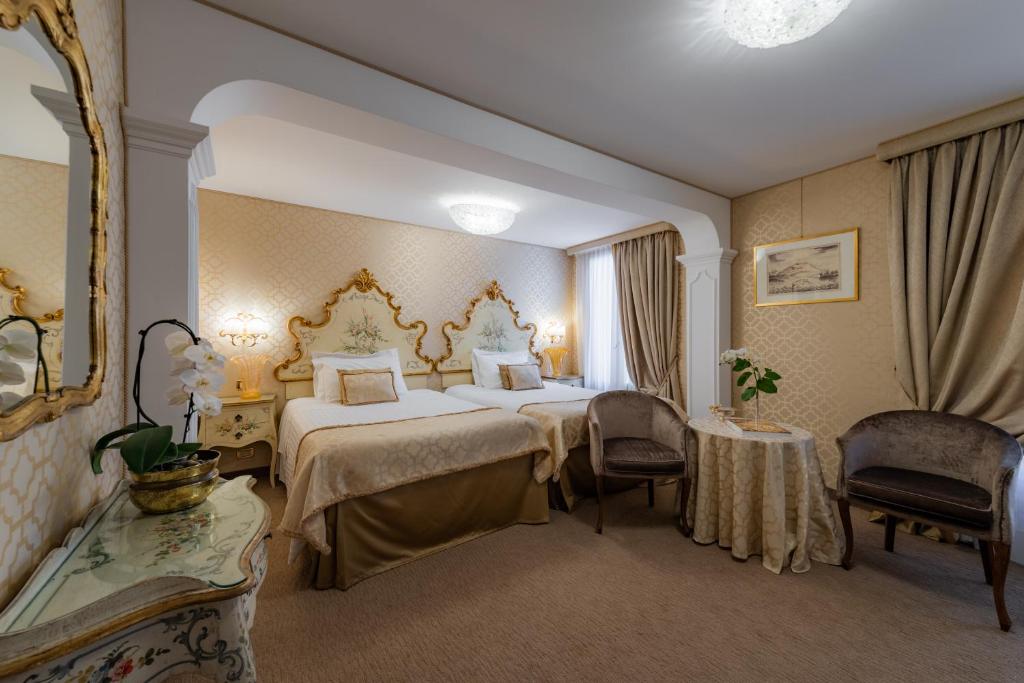 Postel nebo postele na pokoji v ubytování Hotel Concordia
