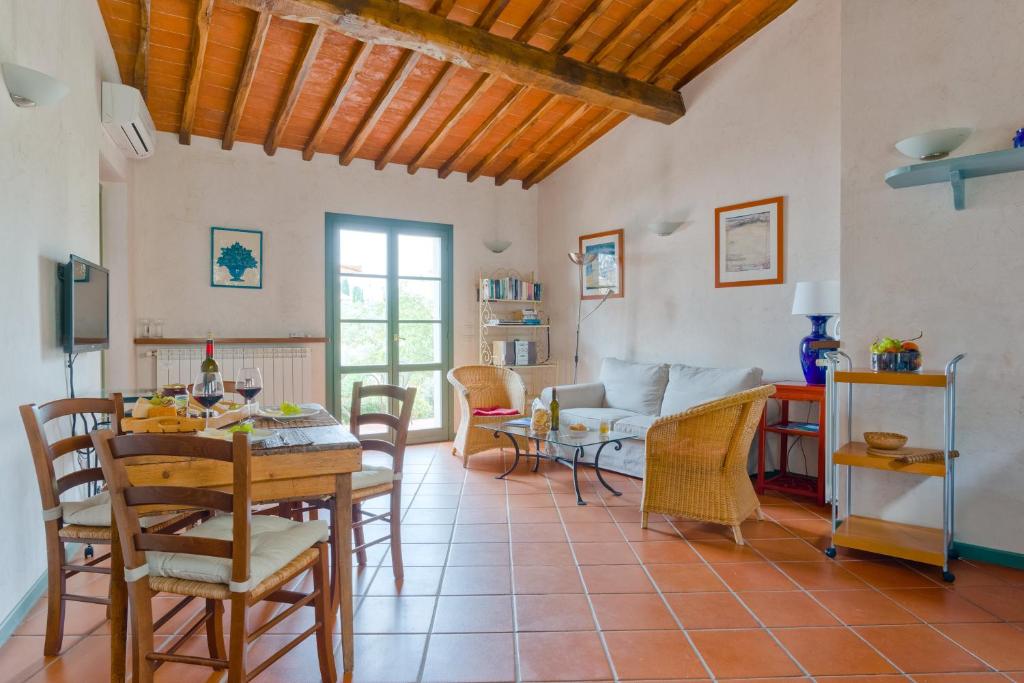 a living room with a table and chairs at Vinaio a Montefiorile in San Sano