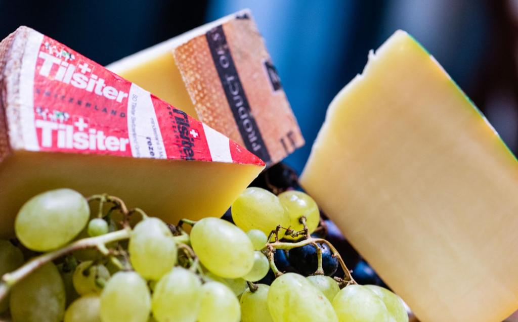 a bunch of grapes and a piece of cheese at Hotel Scheuble in Zürich
