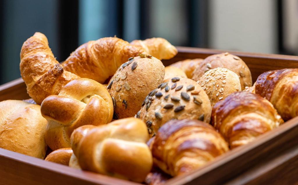 a box filled with lots of different types of bread at Hotel Scheuble in Zürich