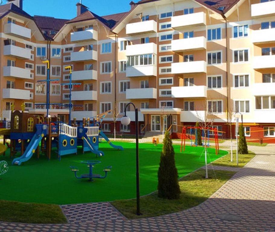 a playground in front of a apartment building at Подобово апартаменти в м Буча in Bucha