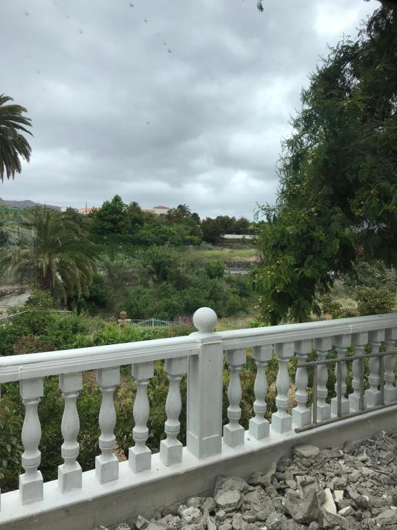 a white fence with a view of a field at La Socorra Suite Adults Only in Fátaga