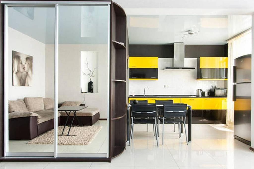 a kitchen and living room with yellow and black at Просторная квартира на улице Бориса Гмыри 4 in Kyiv