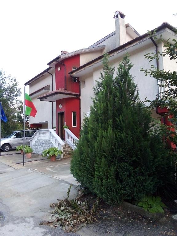 a house with a christmas tree in front of it at Villa Sunny Hill in Fish Fish