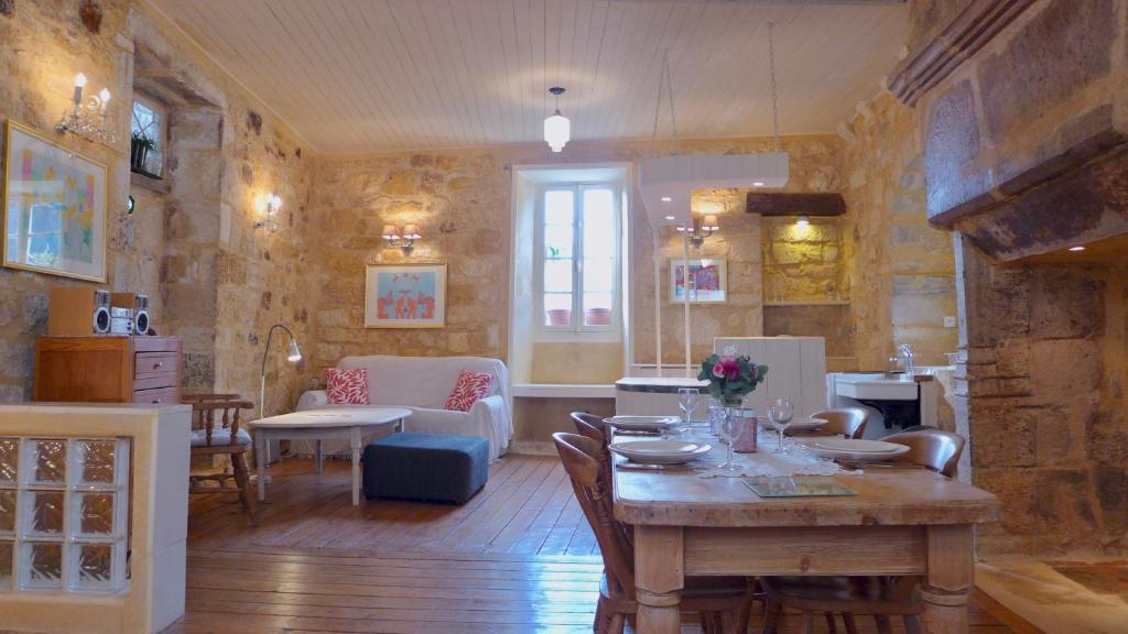a living room with a table and a dining room at Rue Bertrand de Got in Saint-Cyprien