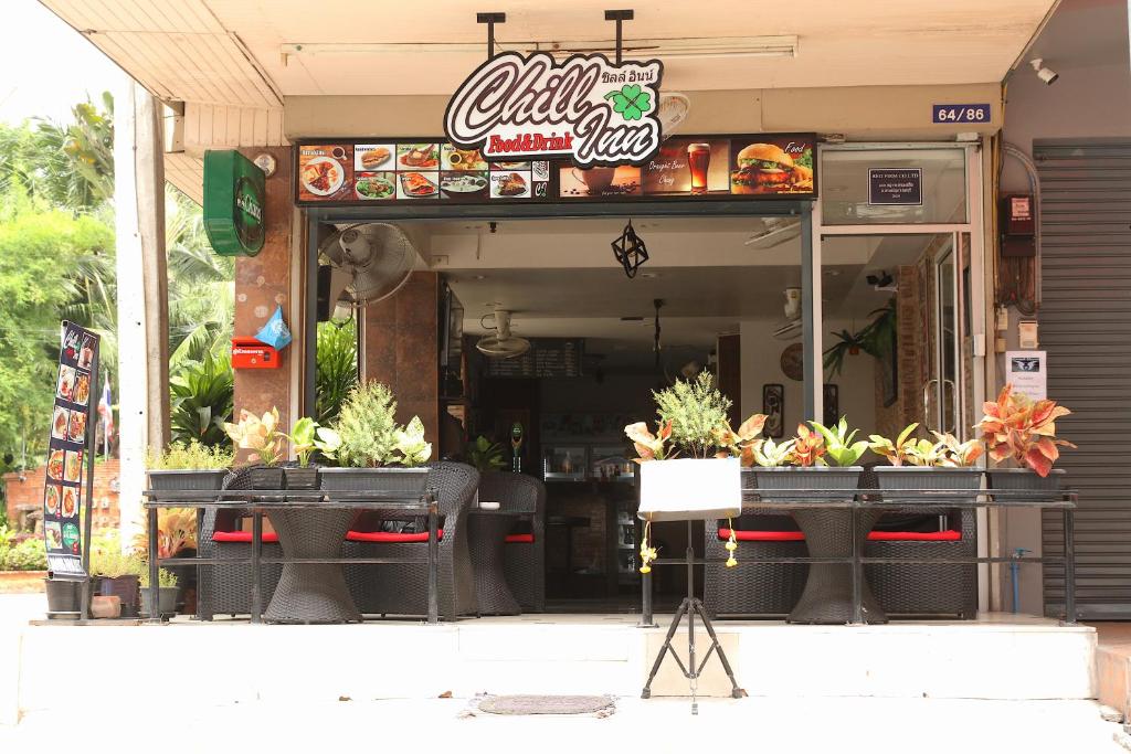 a fast food restaurant with two tables in front of it at Chill Inn in Pattaya Central