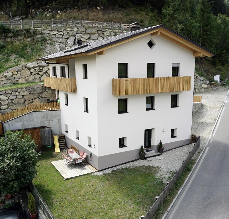 - une vue aérienne sur un bâtiment blanc avec un mur en pierre dans l'établissement Klösterle 2018, à Lutago