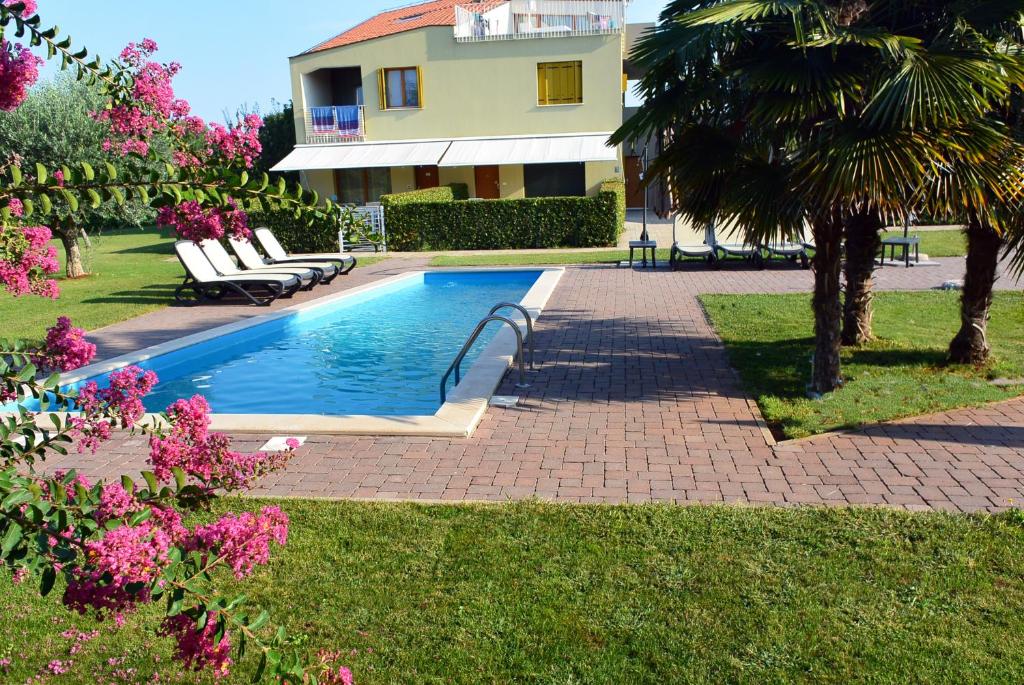 a swimming pool in a yard next to a house at Premium Apartment Maj **** in Poreč