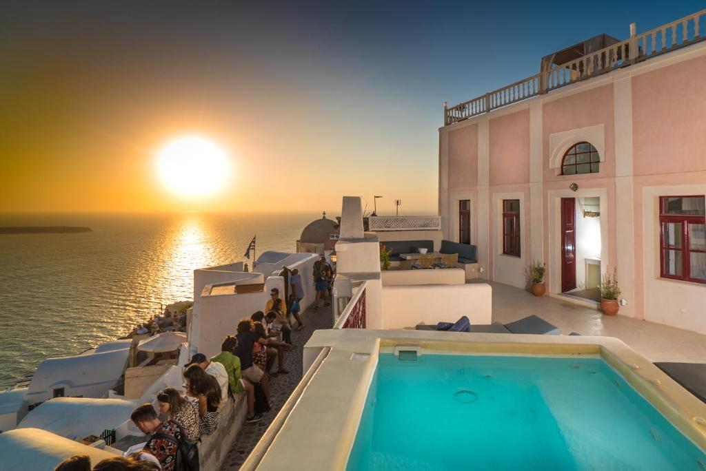 a group of people on a cruise ship looking at the sunset at Poseidon Mansion Sunset in Oia
