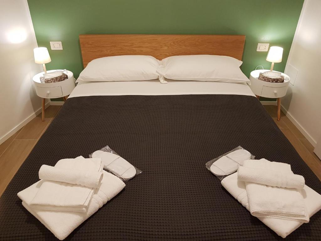 Un dormitorio con una cama con toallas blancas. en Milano Navigli Apartment - Via Savona, en Milán