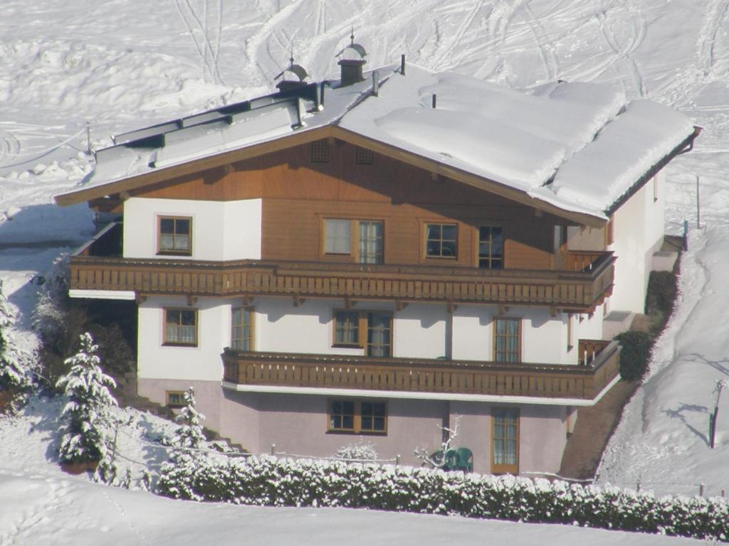 a house with snow on top of it at Landhaus Gensbichler in Saalbach Hinterglemm