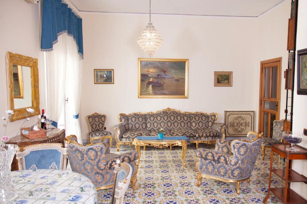 ナポリにあるMaman Suite, city center near Molo Beverelloのリビングルーム(家具、テーブル付)