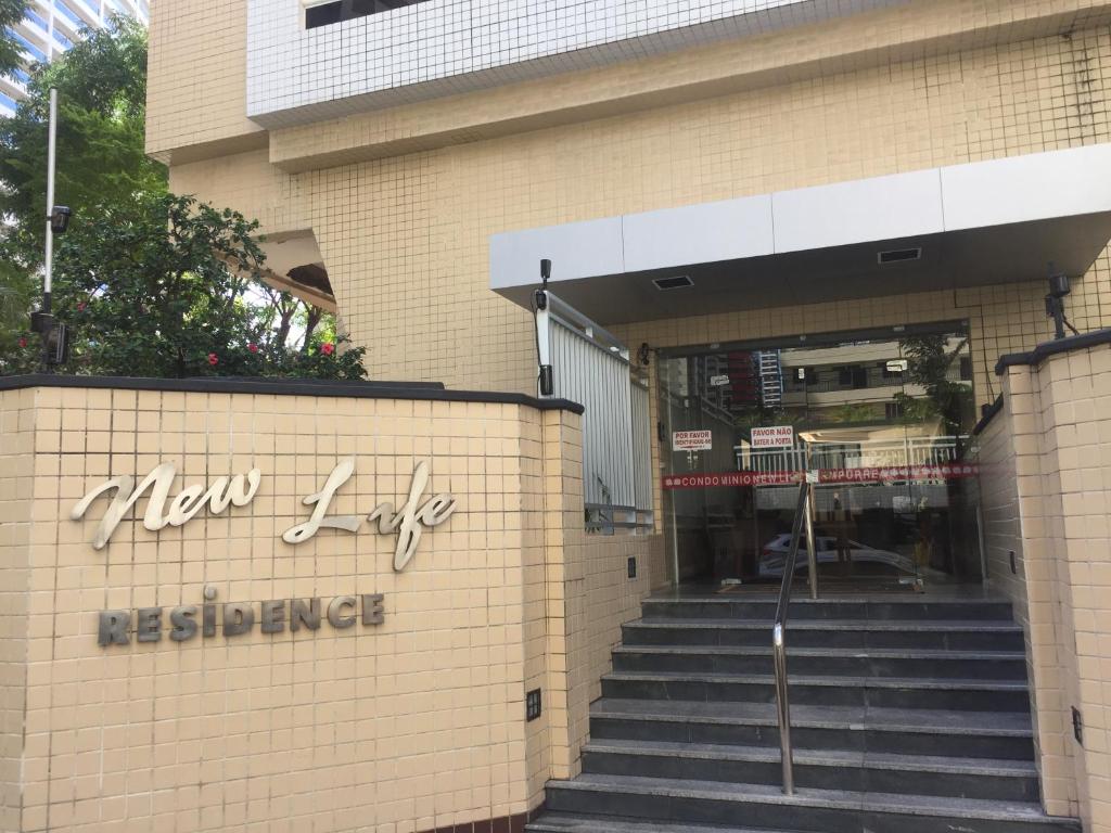 a building with stairs in front of a store at Apartamento New Life in Fortaleza