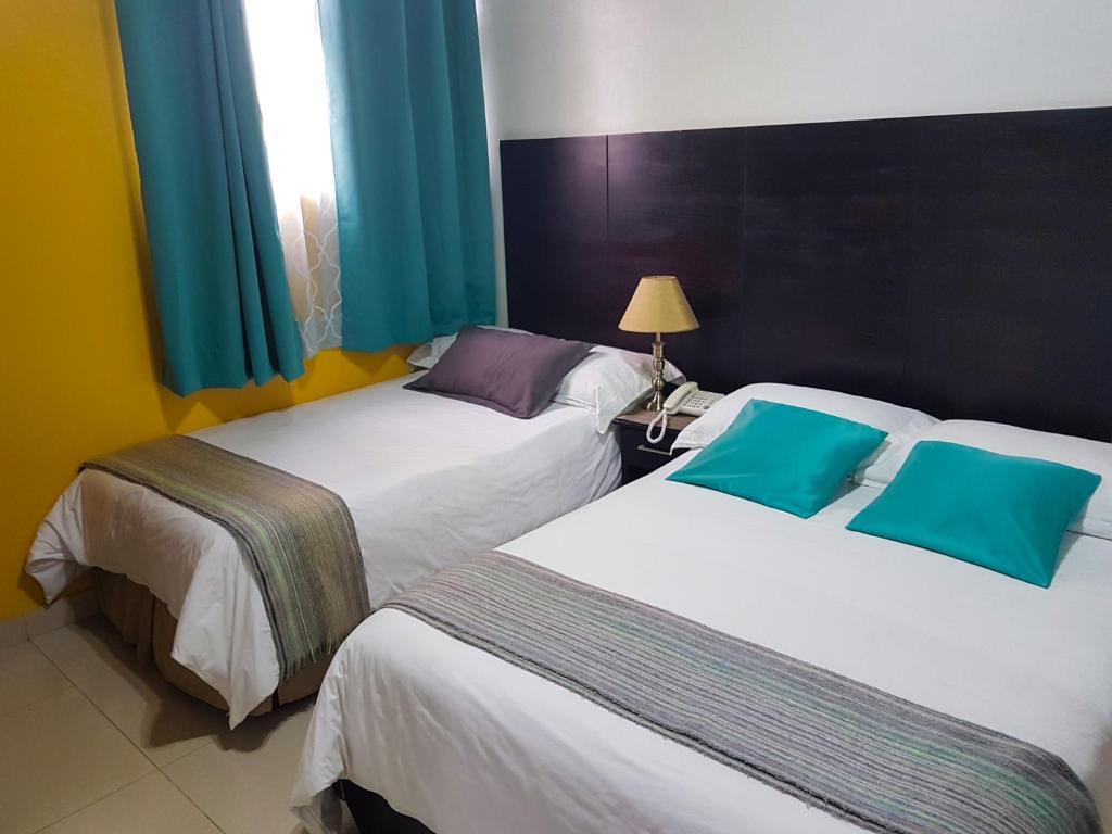 Postel nebo postele na pokoji v ubytování Hostal Blue Pacific