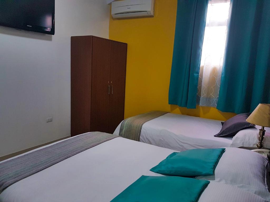 Postel nebo postele na pokoji v ubytování Hostal Blue Pacific