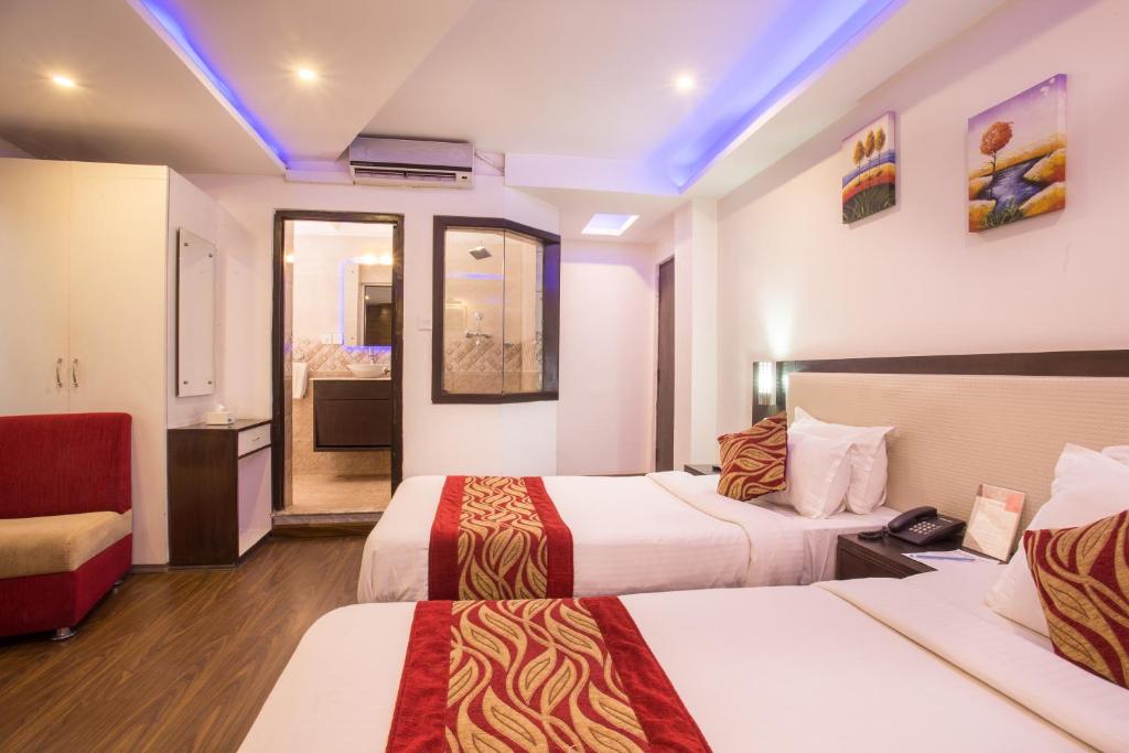 Postel nebo postele na pokoji v ubytování Avataar Kathmandu Hotel