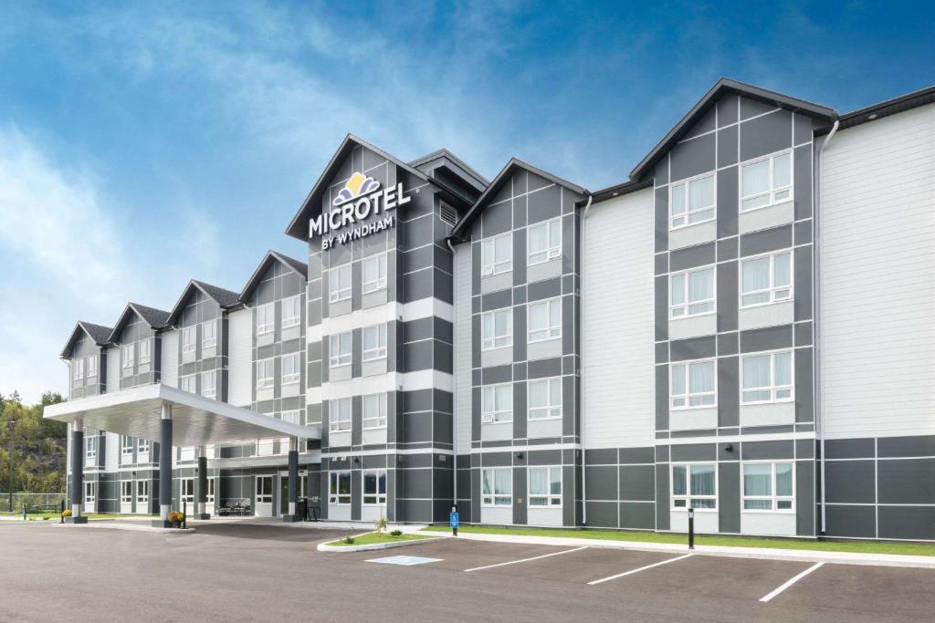 a rendering of the exterior of a morocco hotel at Microtel Inn & Suites by Wyndham Sudbury in Sudbury