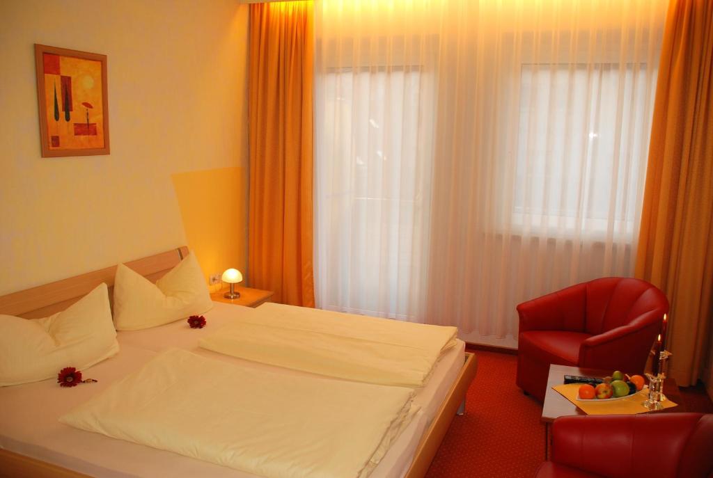 Postel nebo postele na pokoji v ubytování Hotel Heissinger