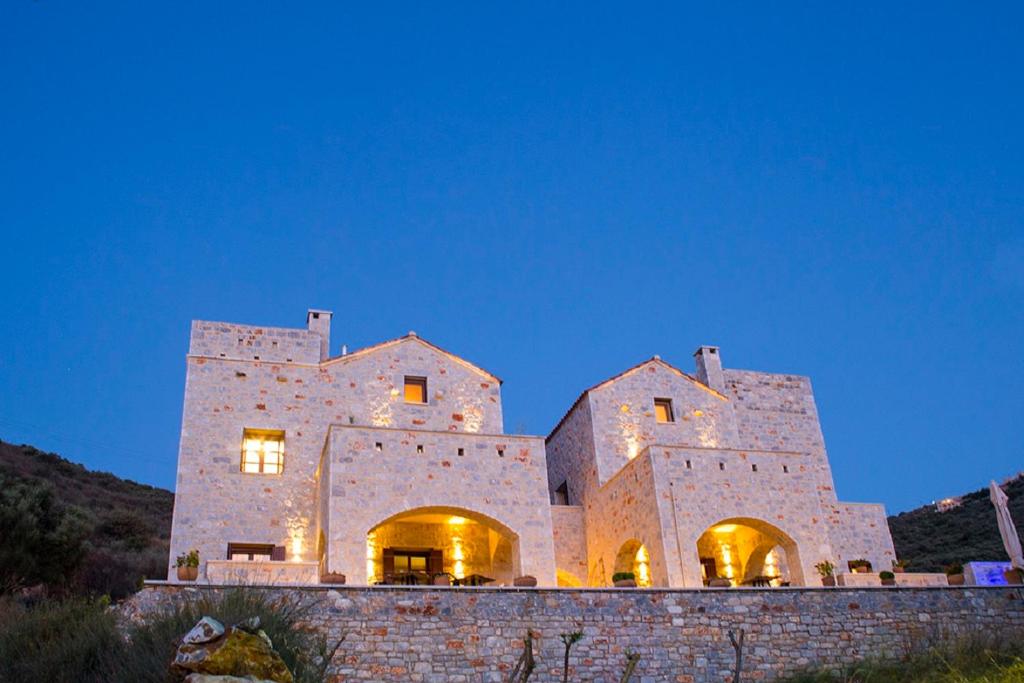 a large stone building on a wall at night at Limeni Inn Boutique Hotel Adults only 12plus in Limeni