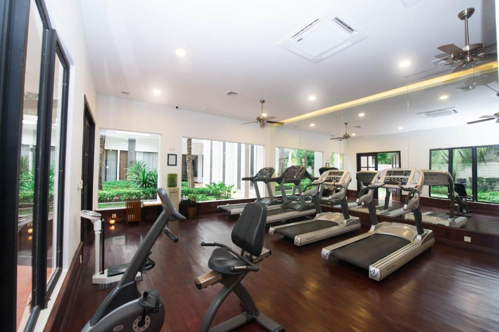 a gym with treadmills and elliptical machines at Lotus Blanc Resort in Siem Reap