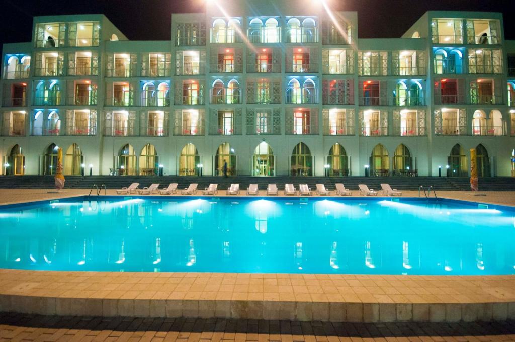 a hotel with a swimming pool at night at Hotel Anaklia in Anaklia